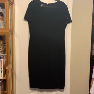 Black cocktail dress with embellished sleeves